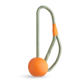The Beco Slinger by The Tetbury Pet Shop & Grooming is an orange natural rubber fetch ball on a gray rope loop with an orange grip, designed for fun, interactive play with your dog.