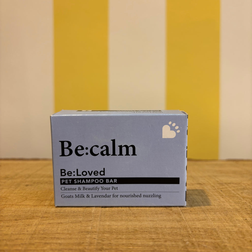 Three boxes of The Tetbury Pet Shop & Grooming's Be: Natural Shampoo Bars are stacked on wood with a yellow and white striped background, showcasing these eco-friendly pet shampoos.