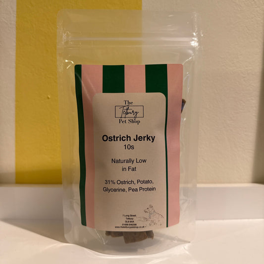 A plastic, air tight bag with 10 sticks of ostrich jerky.  The label has pink and green thick stripes and looks high end with a heritage feel. 31% Ostrich, Potato, Glycerine, Pea Protein.