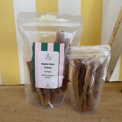 Two clear plastic packaging bags filled with rabbit skin chews for dogs, labeled as 'Rabbit Skin Chews - 20 Pack'.